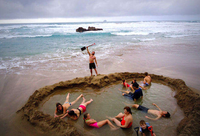People enjoying at the Coromandel Peninsula’s Hot Water beach