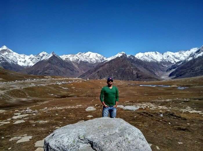 Rajeev in the background of hills in Rohtang Pass