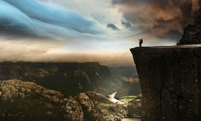 A solo traveler at the edge of a cliff at Preikestolen in Norway