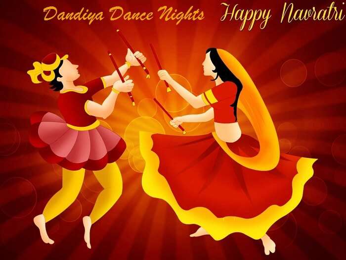 Couple celebrating navaratri and doing dandiya
