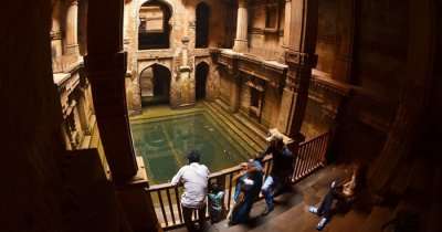 Visitors admire the beauty of architecture and carved walls of Adalaj Ki Vav near Ahmedabad