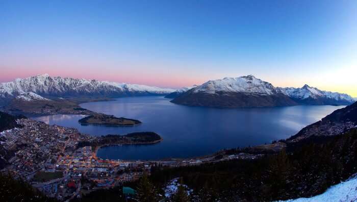 A wide camera shot of the night view of Queenstown in winter