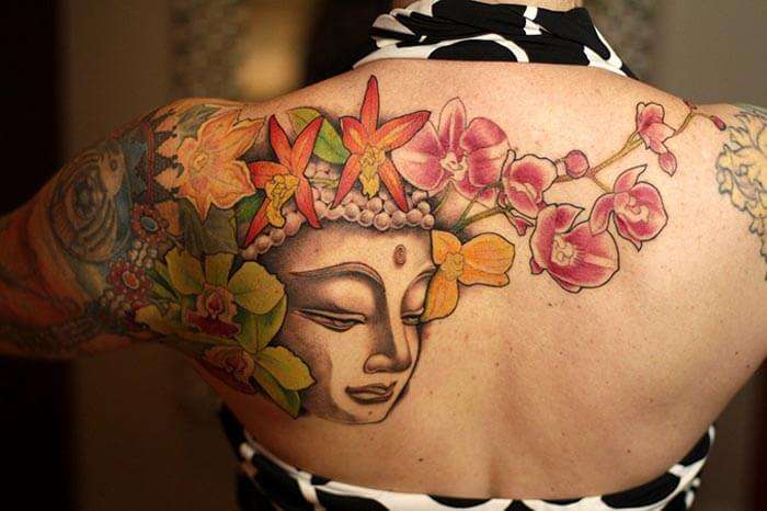 A woman bearing a tattoo at a tattoo parlour in Darjeeling