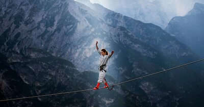 A woman highlining at theInternational Highline Meeting in Monte Piana