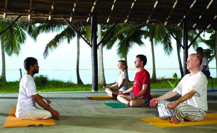 Guests meditating at one of the Yoga sessions at Poovar Island Resort