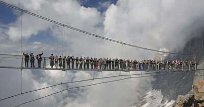 People standing at Austria’s Dachstein Stairway - one of the world’s most dangerous walkways