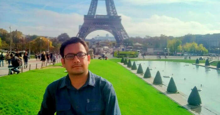 Niket poses in front of Eiffel Tower on his solo trip to Paris