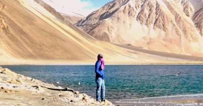 Nikhil stands by the lake in Ladakh
