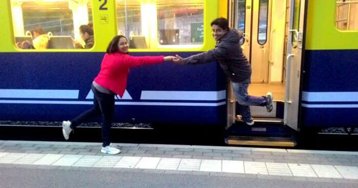 Payal posing in front of a train on her Europe trip