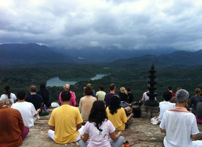 Various people enjoying the serene yoga on Neyyar Dam in Kovalam