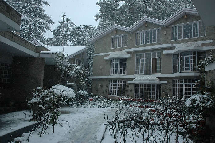 Victorian facade of East Bourne Resort covered in snow in Shimla