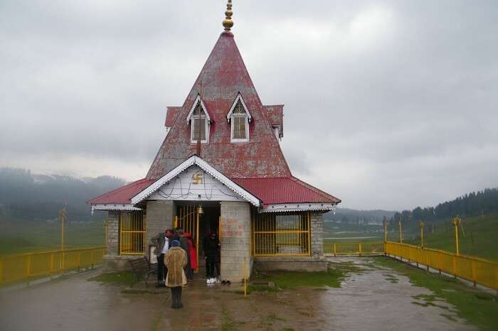 Tourists take blessings at the Maharani Temple in Gulmarg