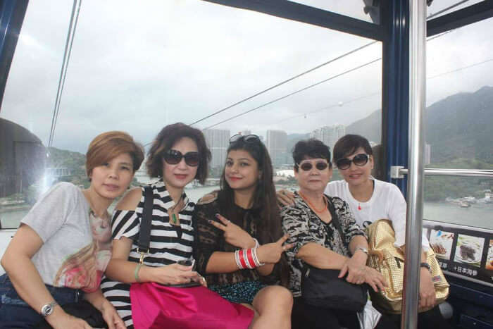 Mituls wife with people in a cable car ride in Hong Kong