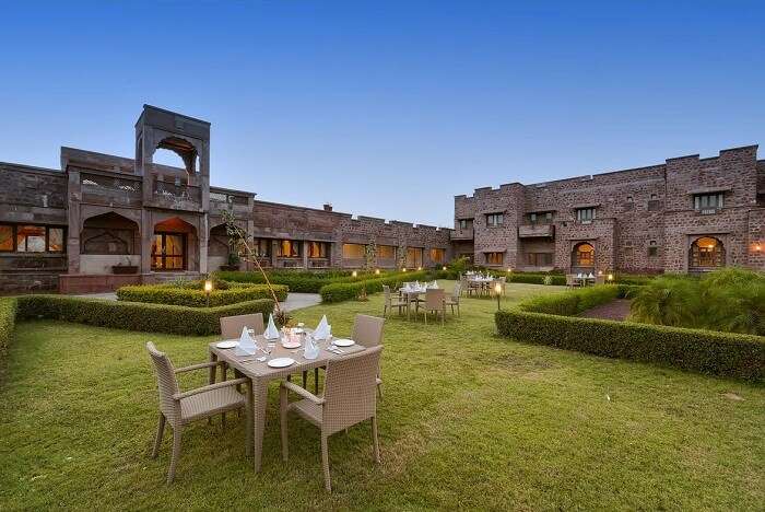 The luxuriant garden and the stonework of the Bijolai Palace hotel in Jodhpur