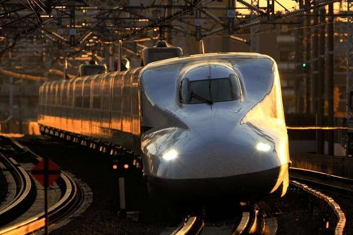 A representative image of the bullet train in India passing through a city