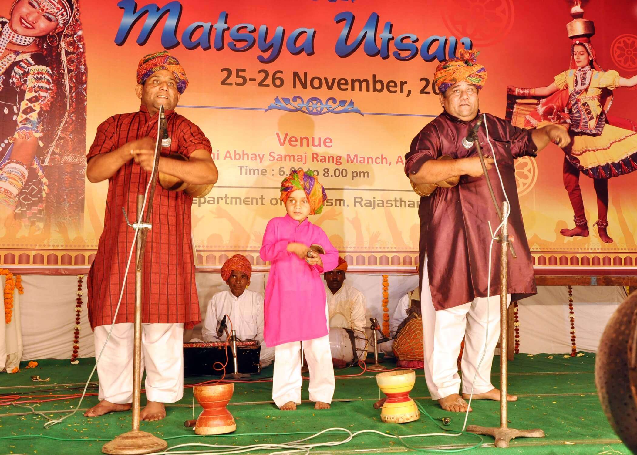 two men and a kid performing in Alwar