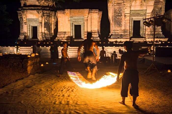 Artists of the Phare Cambodian Circus performing in pront of one of the old temple buildings at night