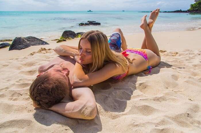 Romantic couple lying on the beach on the beautiful island of Reunion