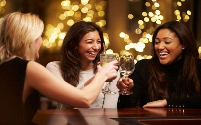 Three women drinking wine