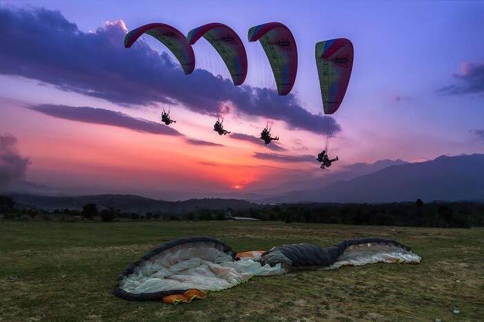 Tourists enjoying paragliding at Bir Billing