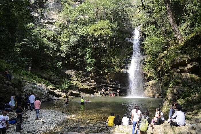 A group enjoying at a waterfall in Mukteshwar