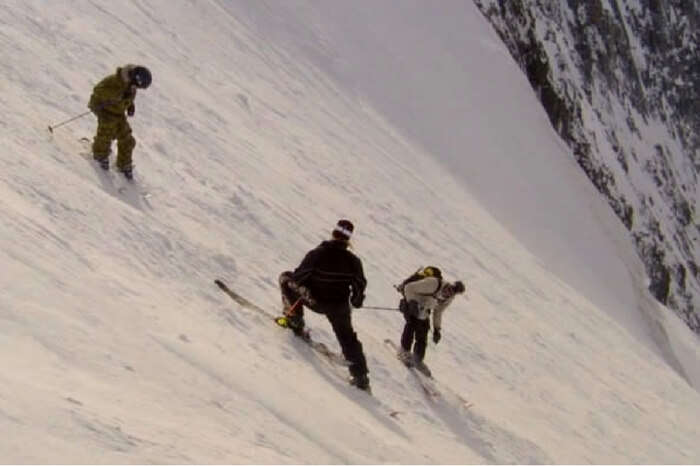Adventurers skiing on the mountain slope in the documentary The Edge of Never