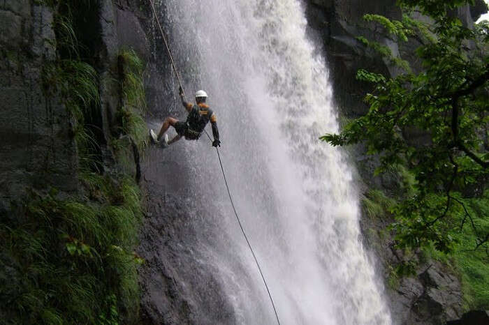 A person tries waterfall rappelling that is one of the best things to do in Chakrata