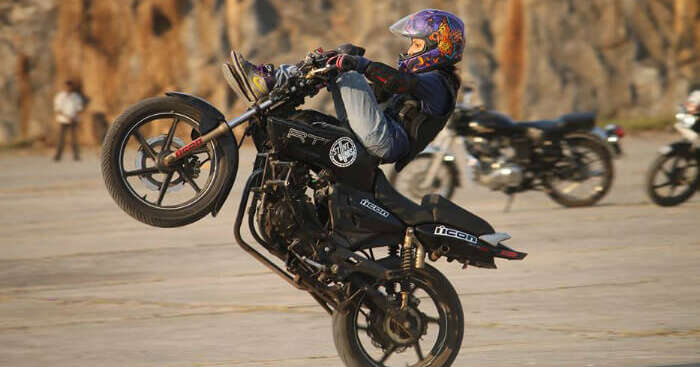 Anam Hashim performing a stunt on a bike