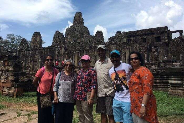standing with my family before the beautiful angkor complex