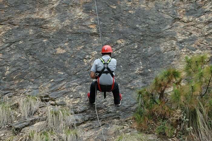 One of the adventurous travelers tries rappelling in Kanatal