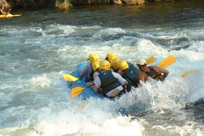 A group of adventure seekers indulge in water rafting in Goa