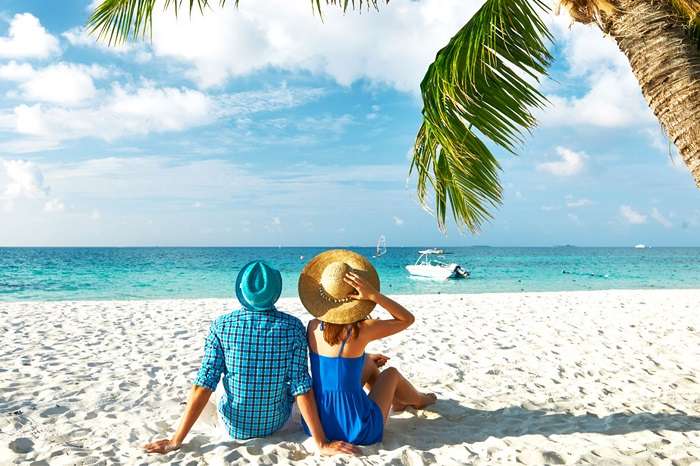 A couple relaxing on a beach in Mauritius