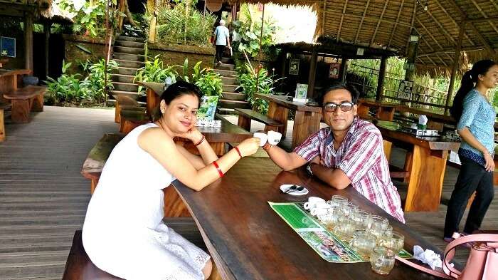 Couple drinking coffee at a coffee farm