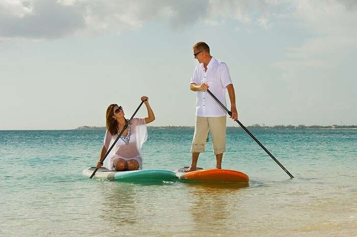 Paddle surfing couple in Grand cayman