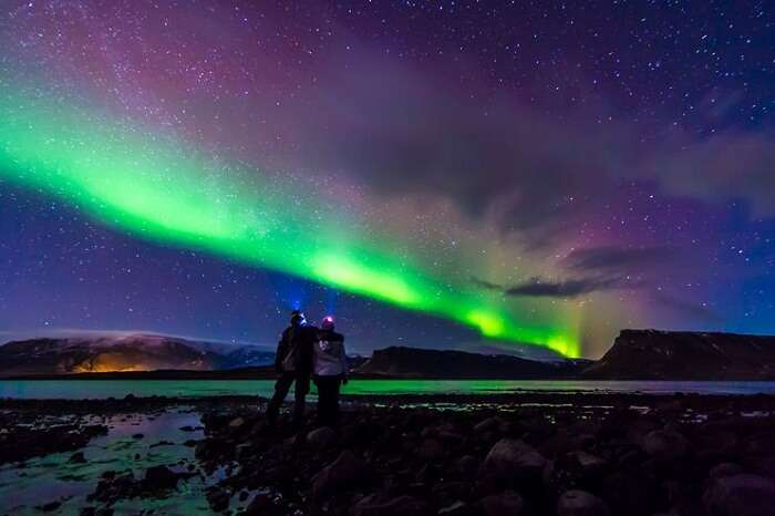 Couple enjoying a romantic night full of stargazing, which is one of the romantic things to do on honeymoon