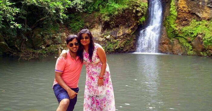 Shashi with his wife standing near a waterfall in Mauritius