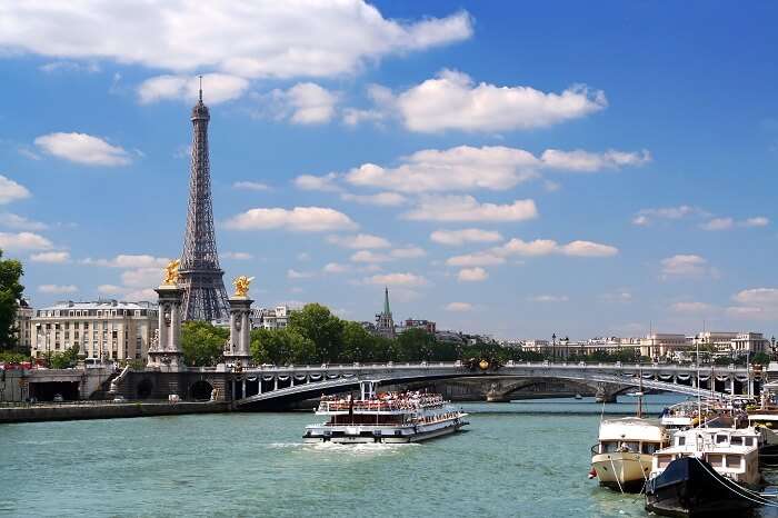 Cruise boat on the Seine under Alexandre III bridge in Paris
