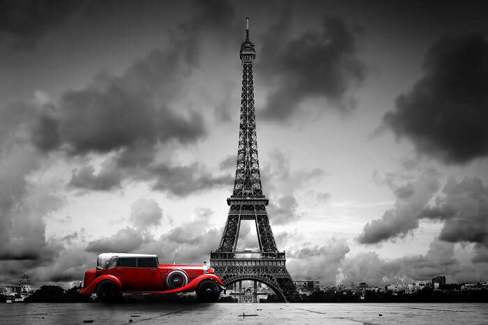 Artistic image of Effel Tower and retro car in Paris
