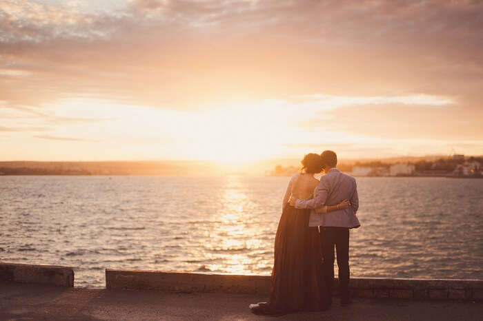 Couple watching a romantic sunrise