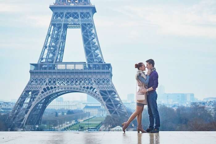 Couple romancing near Eiffel Tower Paris