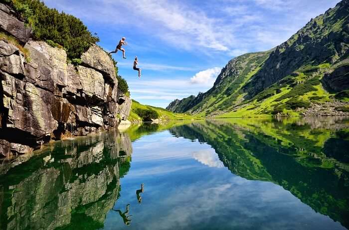 Couple enjoying cliff diving on honeymoon