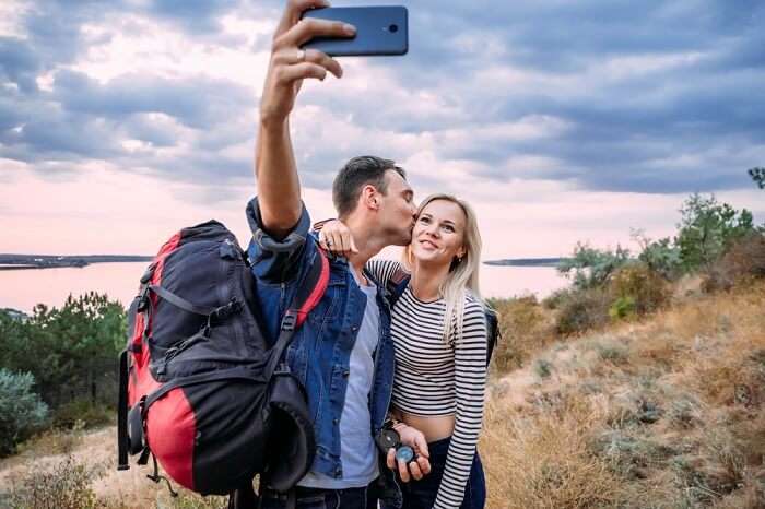 romantic couple taking selfie on honeymoon