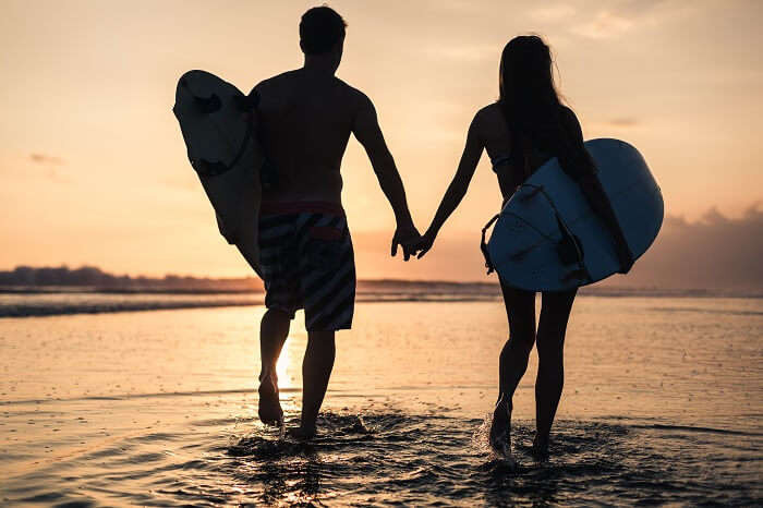 Romantic couple surfing in Uluwatu