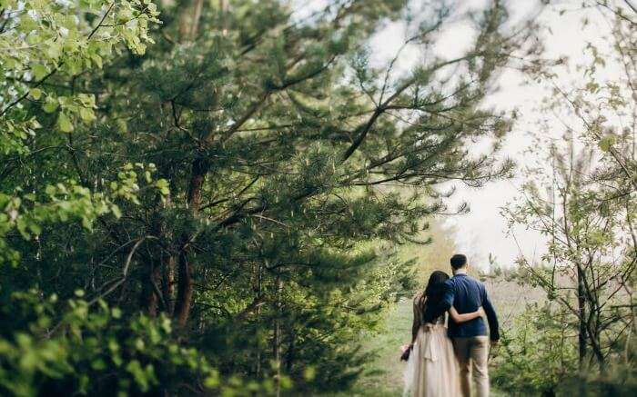 A couple walking in a forest