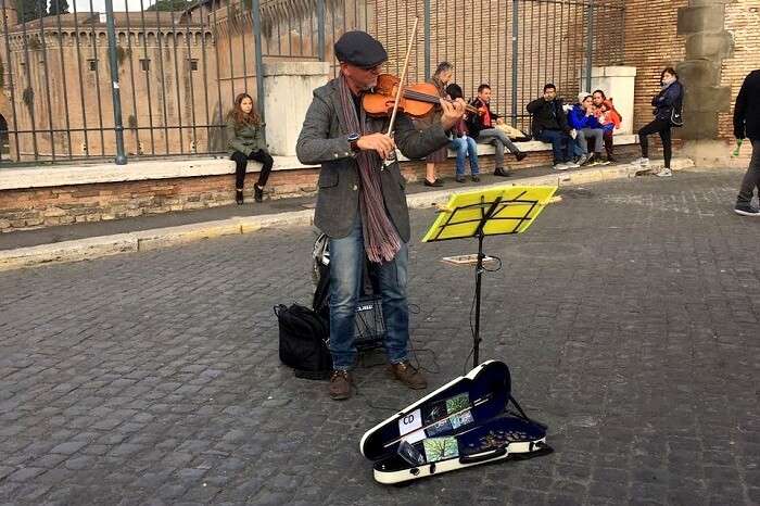 An artist playing a tune in Rome