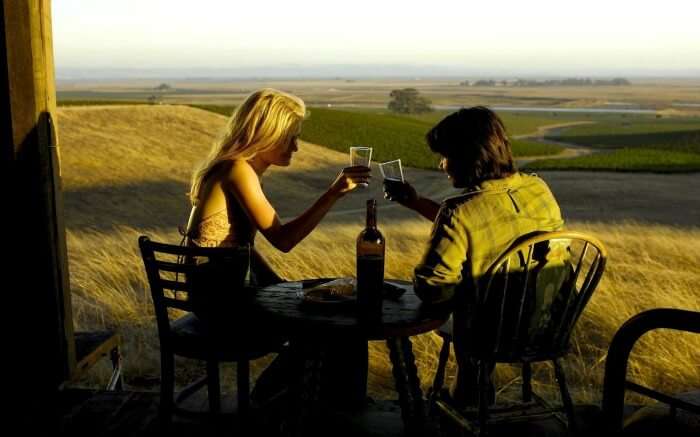  A couple enjoying wine in Tuscany
