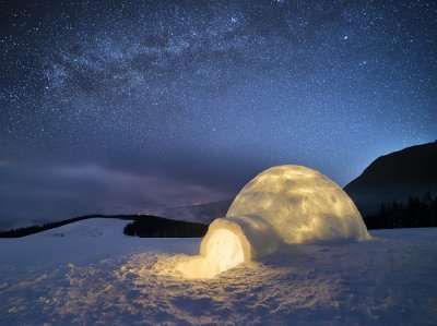 Night landscape with a snow igloo with light
