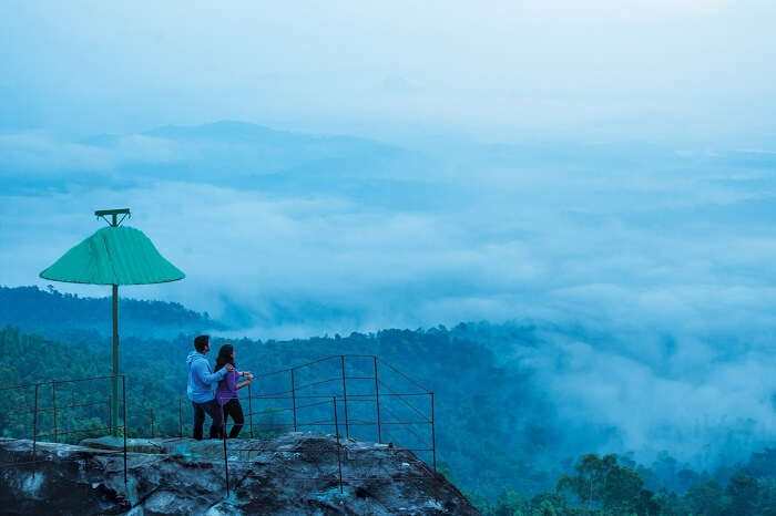 A couple at theview point of Cybe Hill Resort in Wayanad