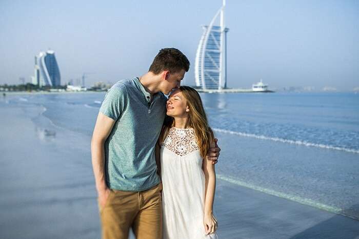 Romantic couple walking on the beach in Dubai