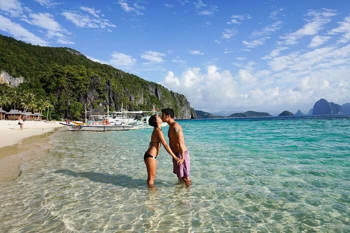 Couple kissing on the beach in El Nido